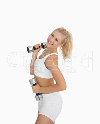 Portrait of woman exercising with dumbbells