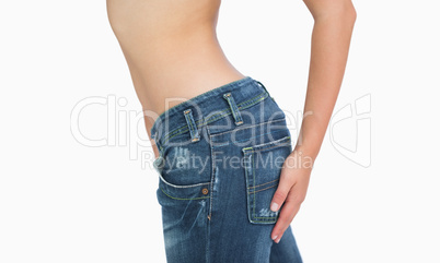 Side midsection of slim woman in jeans