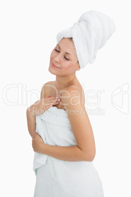 Happy young woman wrapped in towel