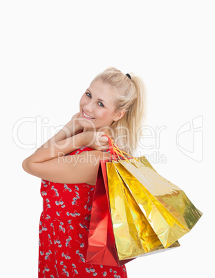 Portrait of cute young woman with shopping bags