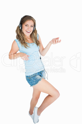 Wwoman enjoying music over headphones and playing air guitar