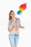 Casual woman using colorful feather duster