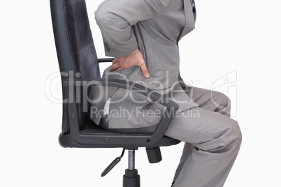 Business man with backache sitting in an office chair