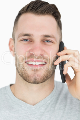Close-up portrait of young man using mobile phone