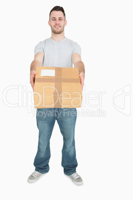 Portrait of young man giving you a package box