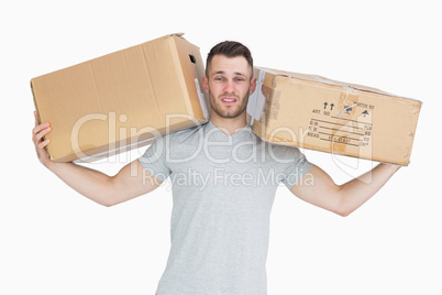 Portrait of tired young man carrying package boxes