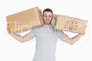 Portrait of tired young man carrying package boxes