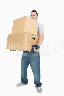 Portrait of young man carrying package boxes