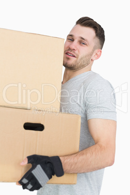 Portrait of tired young man carrying package boxes