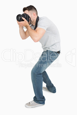 Young male photographer with photographic camera