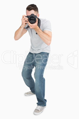 Young male photographer with photographic camera