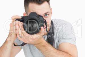 Close-up of male photographer with photographic camera