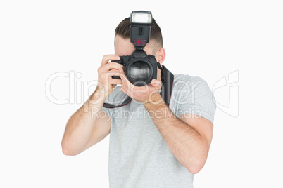 Young male photographer with photographic camera