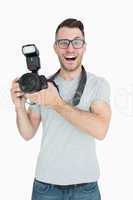 Portrait of cheerful photographer with photographic camera