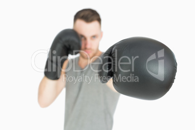 Portrait of young male boxer punching