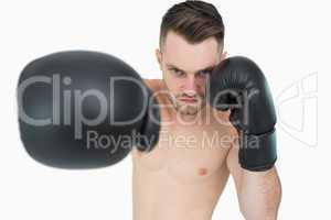 Portrait of young male boxer punching