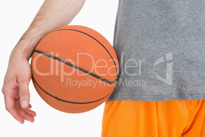 Close-up midsection of man with basketball