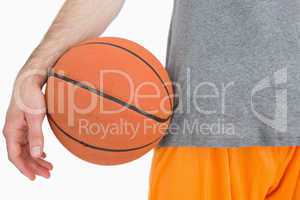 Close-up midsection of man with basketball