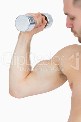 Young man exercising with dumbbell