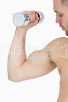 Young man exercising with dumbbell