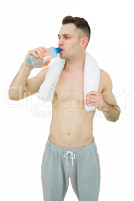Shirtless man drinking water with towel around neck Shirtless man drinking water with towel around neck