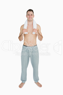 Portrait of happy man holding towel around neck