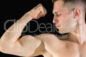 Close-up of young man flexing muscles