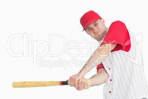Portrait of young baseball player swinging bat