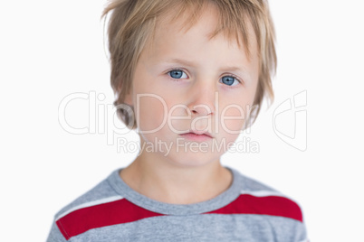 Close-up portrait of cute young boy with blue eyes