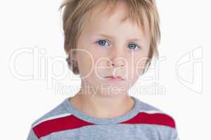 Close-up portrait of cute young boy with blue eyes