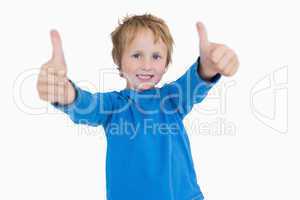Portrait of young boy gesturing double thumbs up