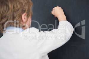 Boy dressed as teacher and writes on black board