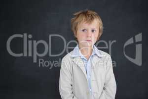 Boy dressed as teacher in front of black board