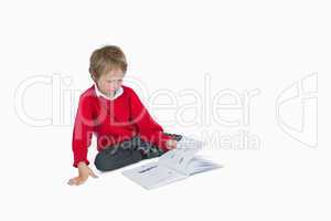 Little boy sitting and reading book