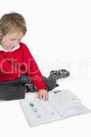 Little boy sitting and reading book