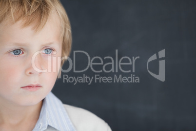 Boy dressed as teacher in front of black board