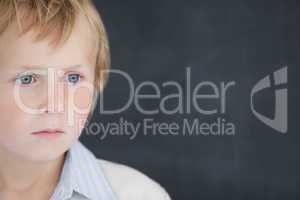 Boy dressed as teacher in front of black board