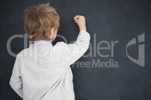 Boy dressed as teacher writes on black board