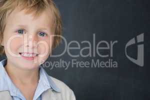 Boy dressed as teacher in front of black board