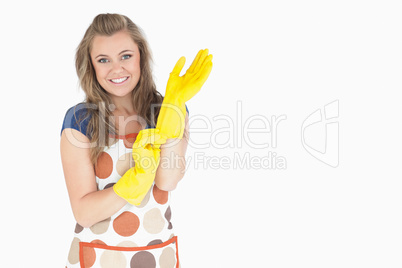 Portrait of smiling young maid with rubber gloves