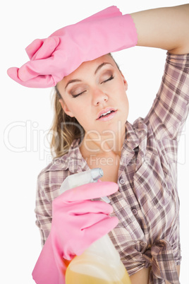 Sleepy young woman holding spray bottle