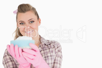 Portrait of smiling woman holding sponge Portrait of smiling woman holding sponge
