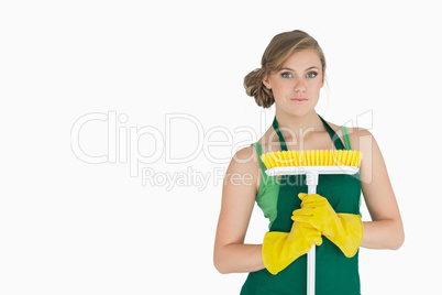 Portrait of young woman with broom