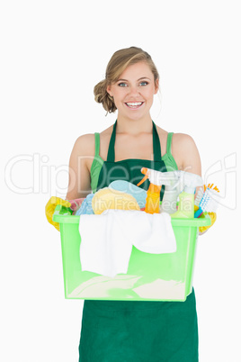 Portrait of young maid carrying cleaning supplies