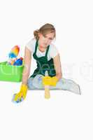 Portrait of young maid cleaning floor