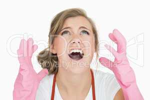Close-up of young maid in pink gloves screaming