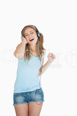 Young woman enjoying music over headphones Young woman enjoying music over headphones