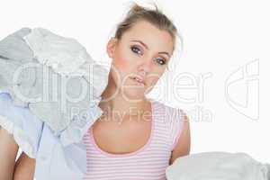 Woman with stack of clothes over white background