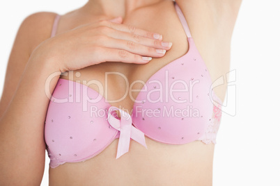 Woman in bra with breast cancer awareness ribbon