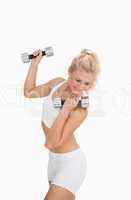 Young woman exercising with dumbbells